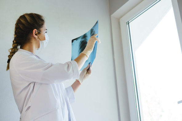 A specialty orthopedics team member examines an x-ray