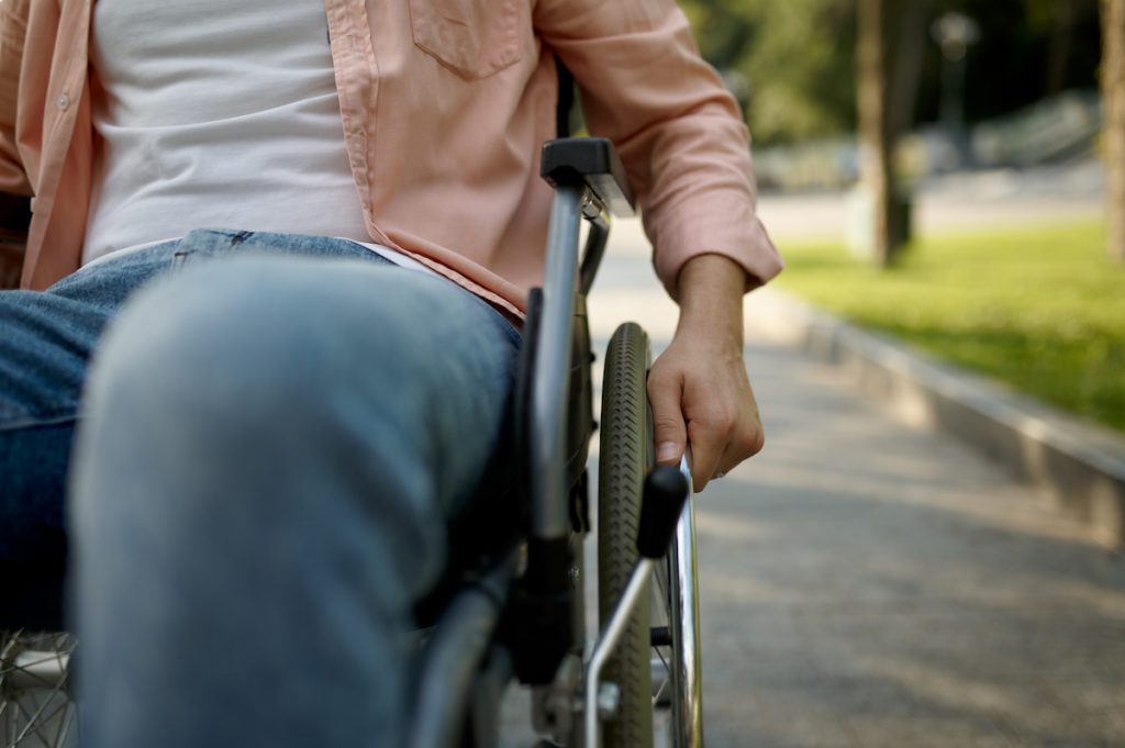 man recovering from an orthopedic surgery in a wheelchair