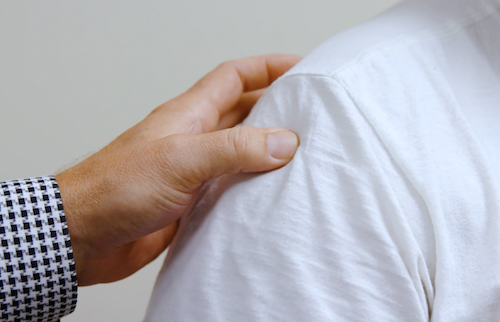 Doctor with hand on a shoulder discussing a torn labrum treatment in Kansas City