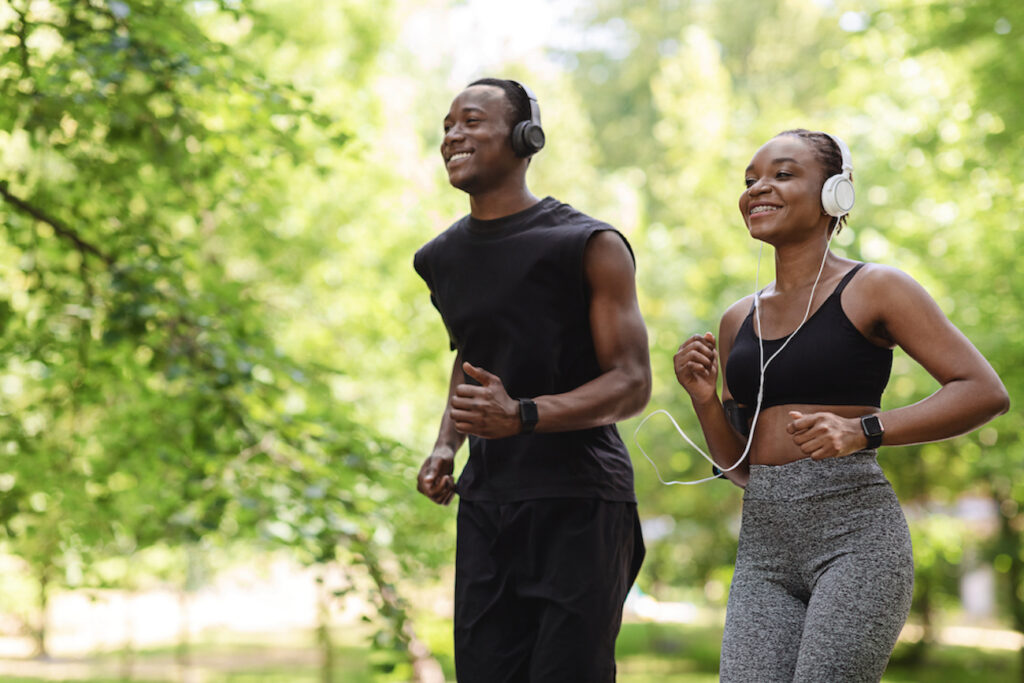 A happy couple jogging to a sports medicine clinic in Kansas City.