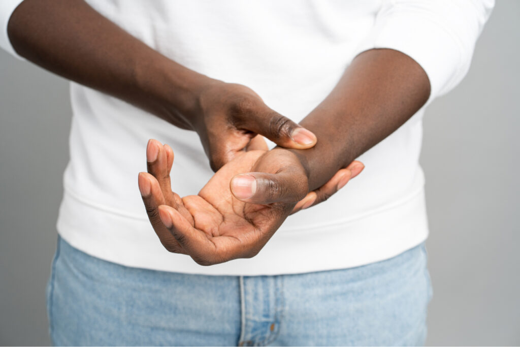 Patient holding wrist an inquiring about carpal tunnel treatments in Lee's Summit