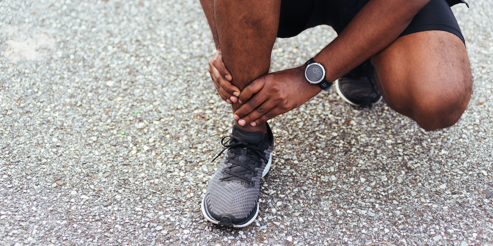 Person in pain needing sprained ankle treatment in Kansas City